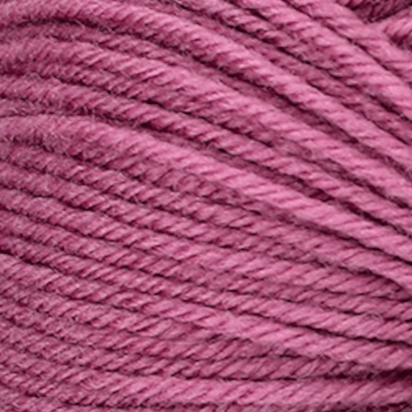 Close-up of soft, finely spun rose pink yarn strands from Ferner Vielseite 210, ideal for knitting and crochet projects requiring quality fiber and smooth texture.