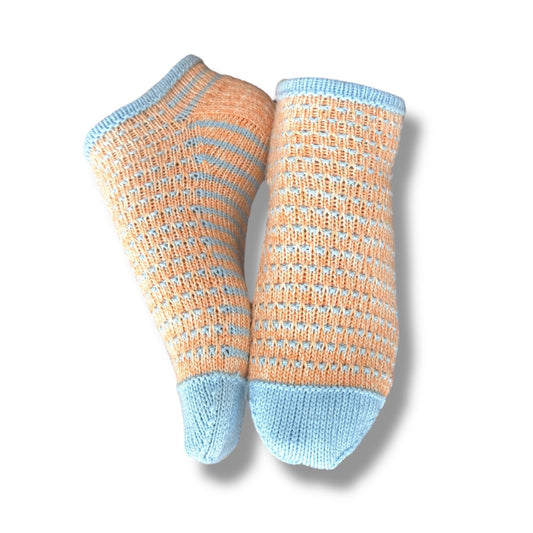 Gestrickte Sneaker Socken in sanftem Apricot mit hellblauen Streifen und Bündchen, gefertigt nach Sneaker Hopsasa Strickanleitung, aus Modal Farbverlaufsgarn zum Verlieben, natürliche Fasern, handgefärbte Wolle.
